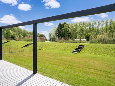 a view of a field from a deck at Holiday Home in Oud Ade near Kaag Lakes in Oud-Ade