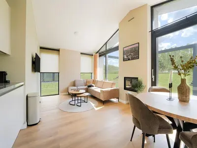 a dining room and living room with a table and chairs at Holiday Home in Oud Ade near Kaag Lakes in Oud-Ade
