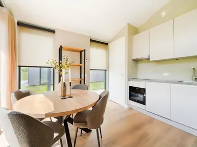 a kitchen and dining room with a wooden table and chairs at Holiday Home in Oud Ade near Kaag Lakes in Oud-Ade