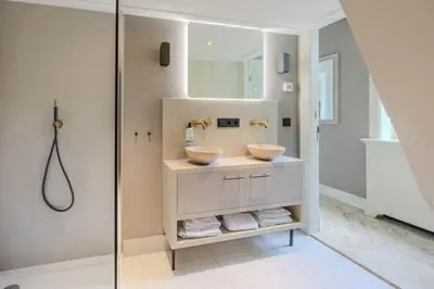 a bathroom with two sinks and a shower at Huize Randenbroek Amersfoort in Amersfoort