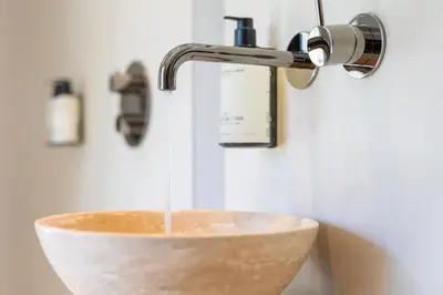 a bathroom sink with water running from a faucet at Huize Randenbroek Amersfoort in Amersfoort
