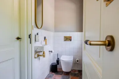 a bathroom with a toilet and a door at Huize Randenbroek Amersfoort in Amersfoort
