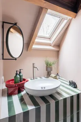 a bathroom with a sink and a skylight at Unique 3 floor apartment with AC at Westerpark in Amsterdam