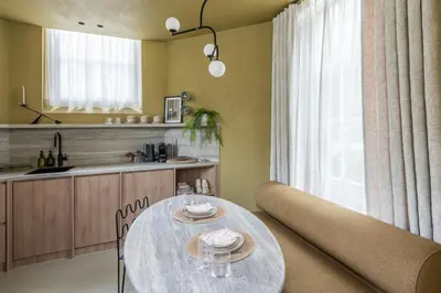 a living room with a table and a kitchen at Unique 3 floor apartment with AC at Westerpark in Amsterdam