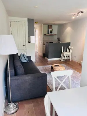 a living room with a couch and a table at Cozy museum area home in Amsterdam
