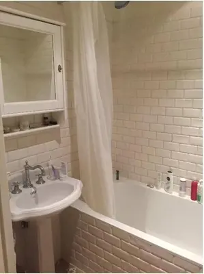 a bathroom with a sink and a bath tub with a mirror at Cozy museum area home in Amsterdam