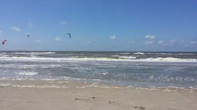 two kites flying over the ocean on the beach at Het Dijkhuysje by ZILT in Warmenhuizen