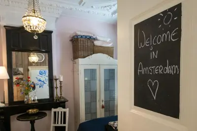 a chalkboard sign on a door in a room at Guesthouseamsterdam in Amsterdam