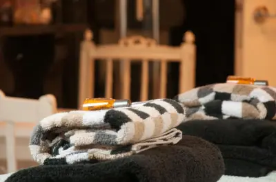 a pile of towels sitting on top of a bed at Guesthouseamsterdam in Amsterdam