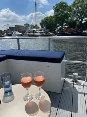 two glasses of wine sitting on a table on a boat at Bed en B-ootje in Bunschoten