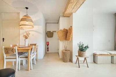 a dining room with a table and chairs at Beachhouse Jula in Egmond aan Zee