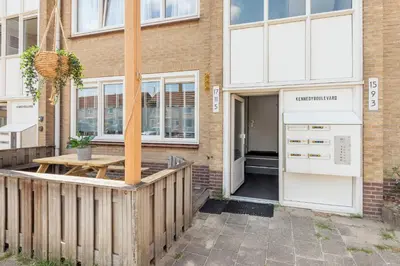 a building with a wooden fence next to a door at Beachhouse Jula in Egmond aan Zee