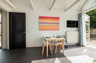 a dining room with a table and chairs at Dune Haven in Schoorl