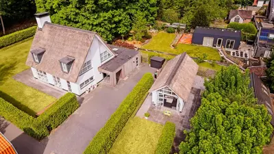 an aerial view of a house with a yard at Dune Haven in Schoorl