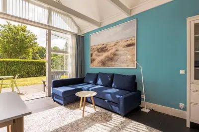 a blue living room with a blue couch at Dune Haven in Schoorl