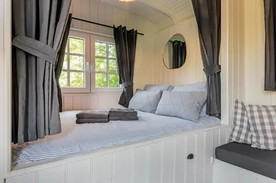 a bed in a room with a window at Nature lovers Amsterdam Zaandam in Wijdewormer