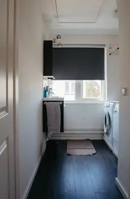 a laundry room with a sink and a window at Perla di Robbie in Zandvoort