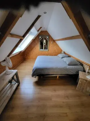 a bedroom with a bed in a attic at De Gortla in Oosterblokker