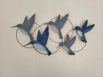 three birds in a hoop on a wall at De Gortla in Oosterblokker