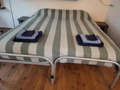 a bed with two towels on top of it at De Gortla in Oosterblokker