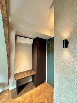 a closet with a wooden bench in a room at Rembrandt & Vermeer in Amsterdam