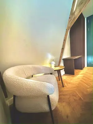 a living room with a chair and a table at Rembrandt & Vermeer in Amsterdam