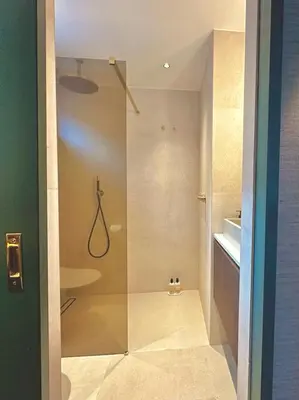 a shower with a glass door in a bathroom at Rembrandt & Vermeer in Amsterdam