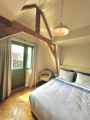 a bedroom with a large bed and a window at Rembrandt & Vermeer in Amsterdam