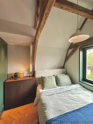 a bedroom with a bed and a window at Rembrandt & Vermeer in Amsterdam