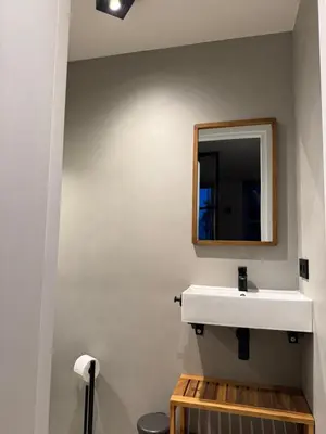 a bathroom with a white sink and a mirror at Casa del Cisne 4 in Zandvoort
