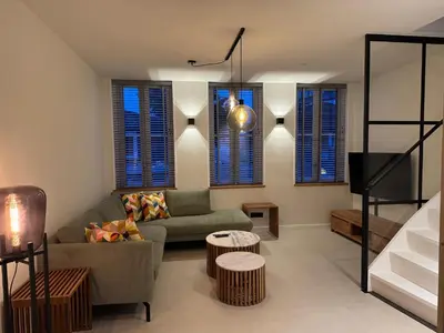 a living room with a couch and a table at Casa del Cisne 4 in Zandvoort