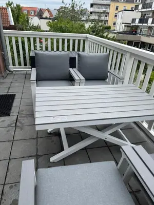 a white bench sitting on top of a balcony at Casa del Cisne 4 in Zandvoort