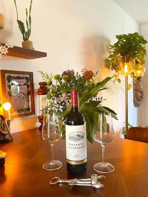 a bottle of wine sitting on a table with two glasses at Canal House with a Unique View in Amsterdam