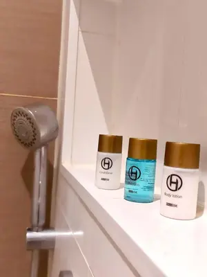 three bottles of moisturizers sitting on a shelf in a bathroom at Canal House with a Unique View in Amsterdam