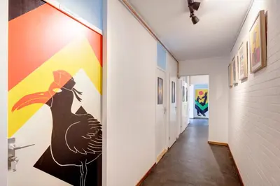 a hallway with a painting of a peacock on the wall at Apartment Hotel Zuid Oost Heesterveld BnB ZOH in Amsterdam