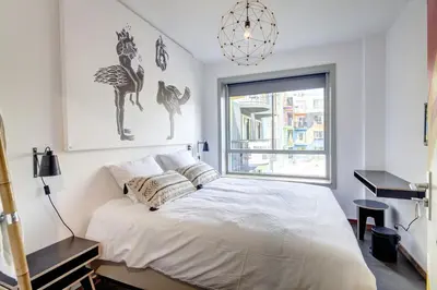 a white bedroom with a bed and a window at Apartment Hotel Zuid Oost Heesterveld BnB ZOH in Amsterdam