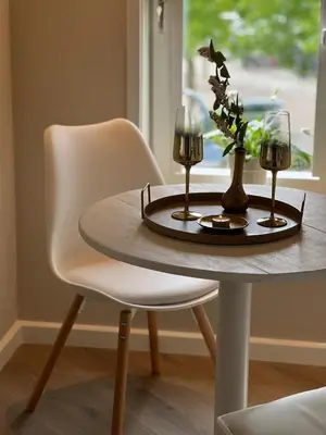 a table with two glasses and a vase on it at Luxury Private Spa with golden bath, cinema and sauna in Bodegraven