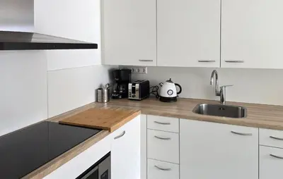a kitchen with white cabinets and a sink at 1 Bedroom Lovely Home In Heiloo in Heiloo
