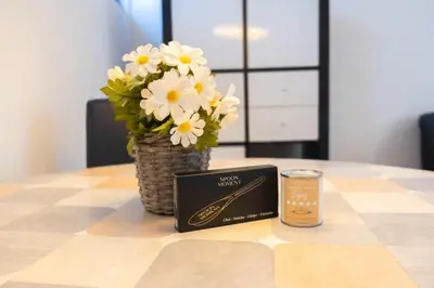 a book sitting on a table with a vase of flowers at Duinrust in Egmond aan Zee