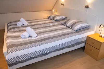 a bedroom with a bed with two pillows on it at Duinrust in Egmond aan Zee