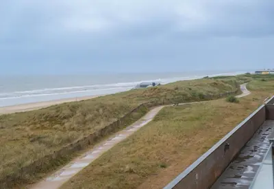 a view of the beach from the balcony at Seaviews Egmond in Egmond aan Zee