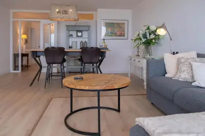 a living room with a couch and a table at Seaviews Egmond in Egmond aan Zee