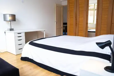 a bedroom with a bed with a desk and a table at Verdronkenoord57 in Alkmaar