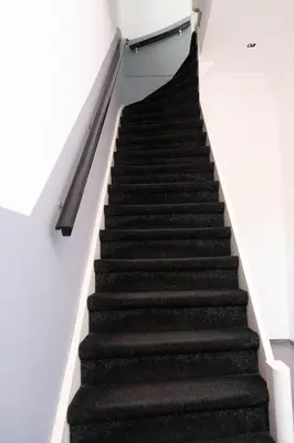 a staircase in a building with black carpet at Verdronkenoord57 in Alkmaar