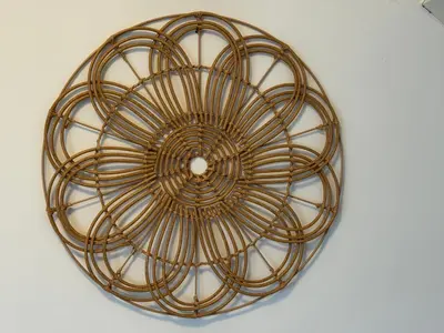a brown wicker ceiling light on a white wall at Zon Zee en Duin Egmond Strandhuisje in Egmond aan Zee