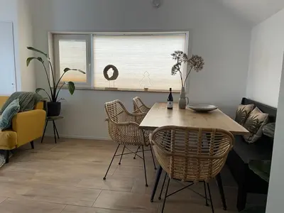 a living room with a table and chairs and a couch at Private Tiny House in Bussum near Amsterdam! in Bussum