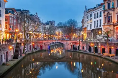 a bridge over a canal in a city at night at Private Tiny House in Bussum near Amsterdam! in Bussum
