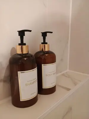 two bottles of soap sitting on a shelf at Het Haven Huysje in Hoorn