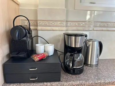 a kitchen counter with a blender and cups on it at Cozy Guesthouse 15 min Amsterdam Haarlem Zandvoort in Zwanenburg