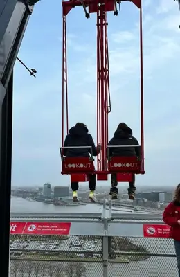two people sitting in chairs on a crane at Cozy Guesthouse 15 min Amsterdam Haarlem Zandvoort in Zwanenburg
